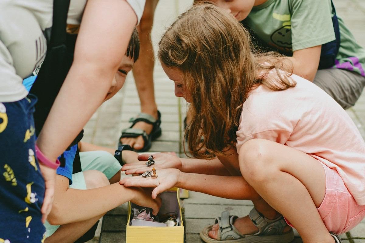 Children sitting on the ground playing a game