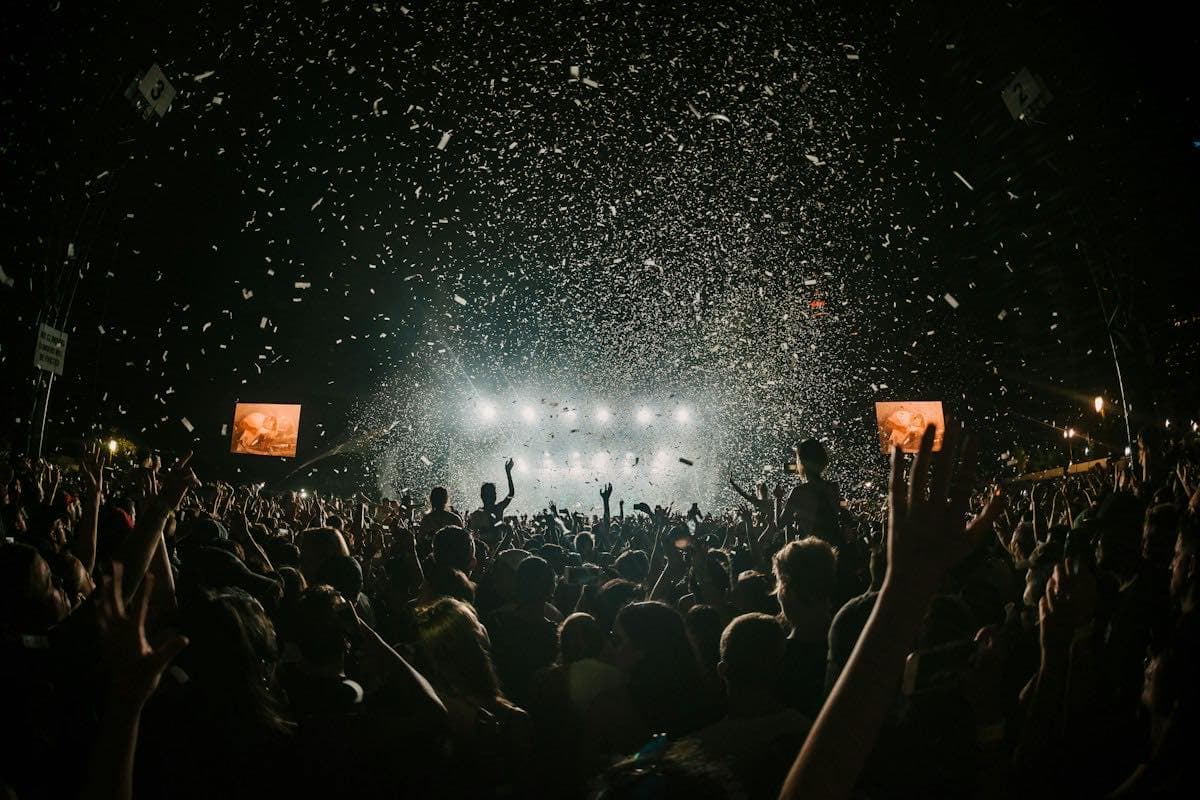 A crowd at an outdoor festival stage