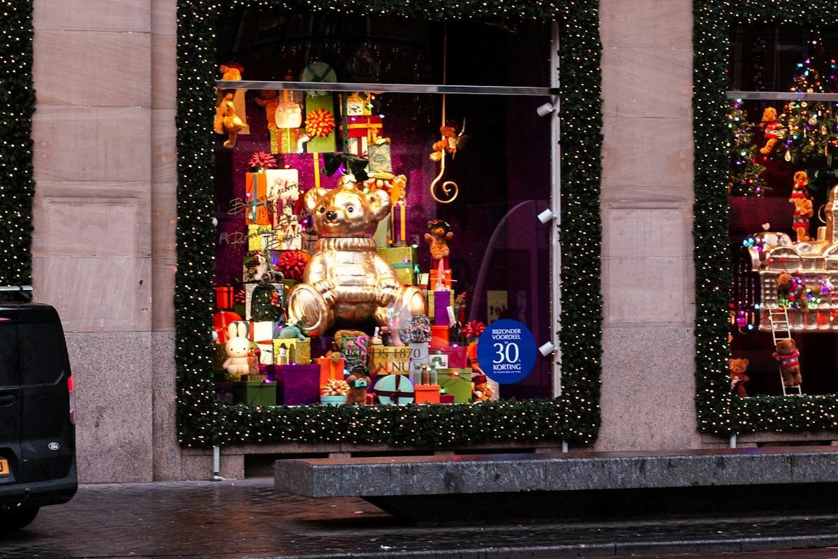 A shop window display with a teddy bear