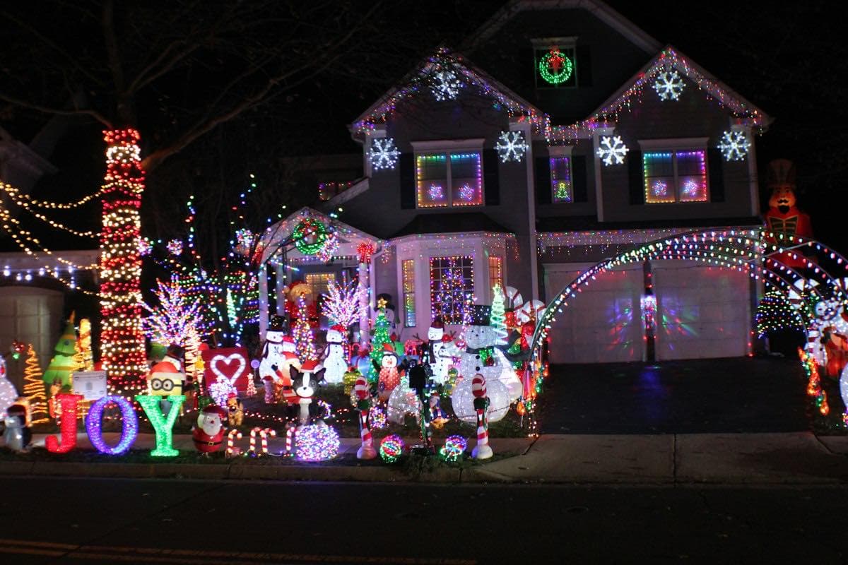 A house covered in holiday lights at night