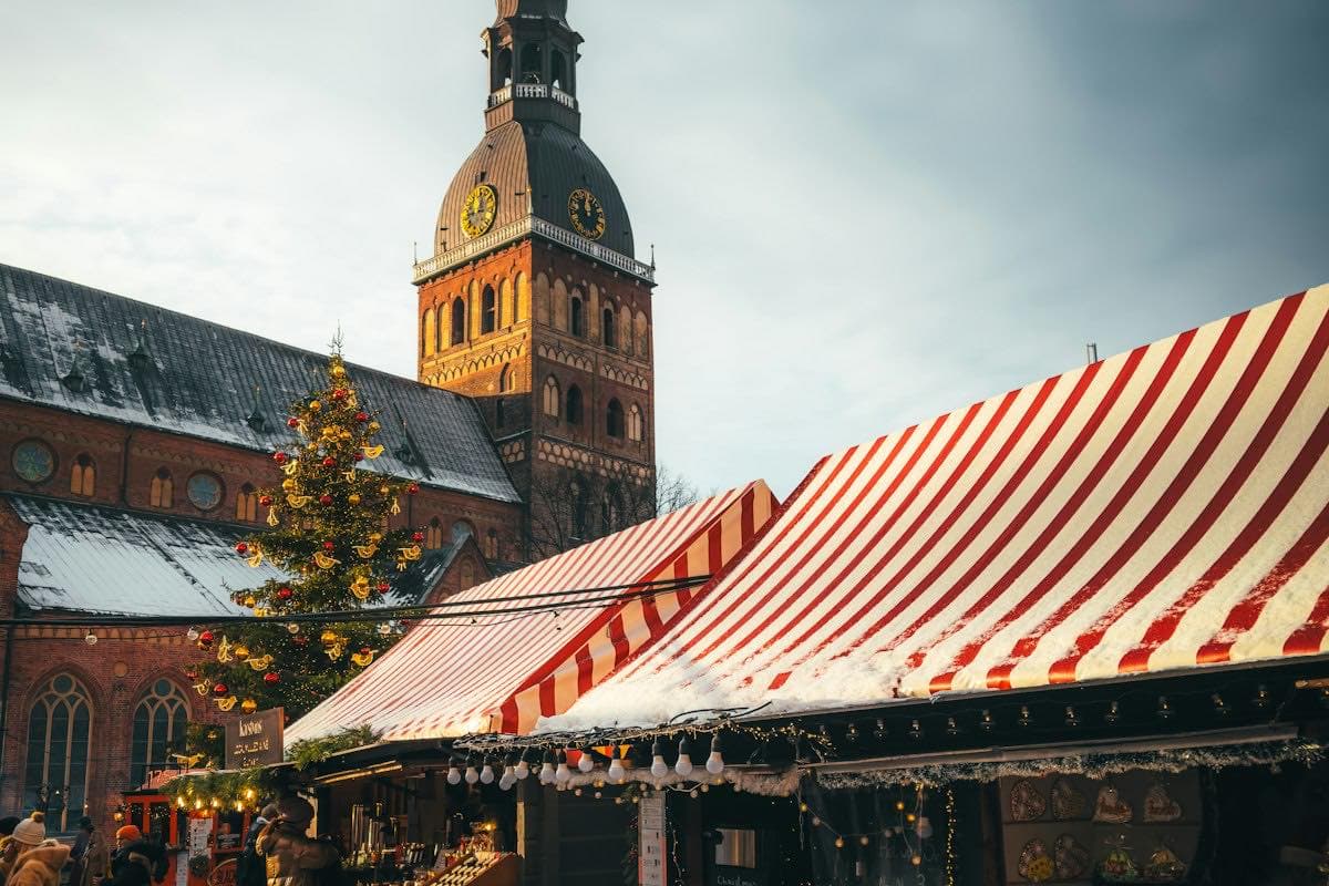 A holiday market in a town square with a clock tower