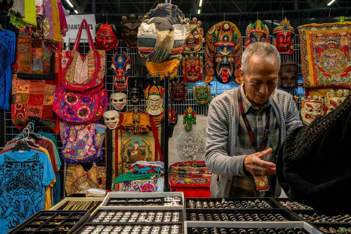 A vendor selling handmade jewelry at a market stall